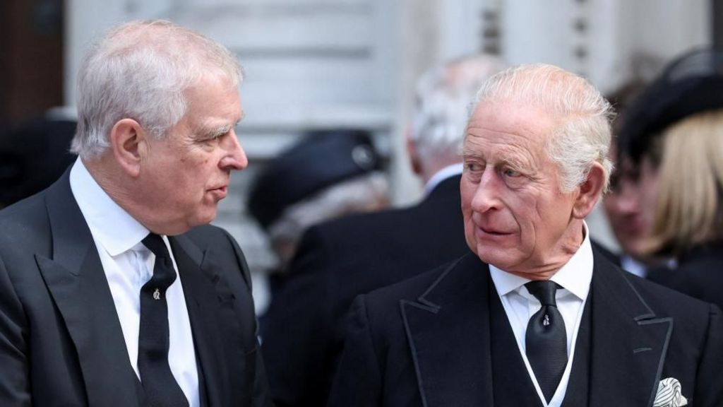 Prince Andrew speaks with King Charles at the funeral of Katharine, Duchess of Kent, in September. Both are wearing black suits and white shirts.