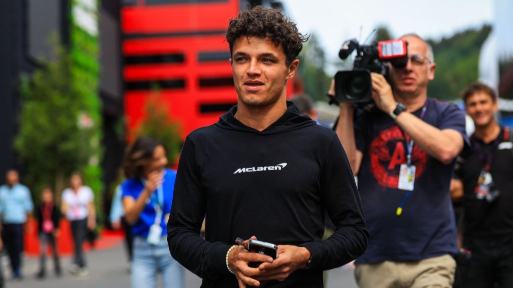 Lando Norris is filmed by a camera man as he enters the Belgian paddock 