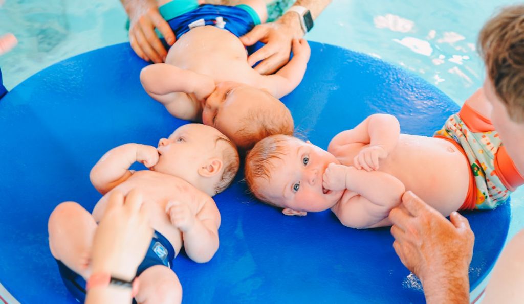 Three babies in a circle in swimming costume