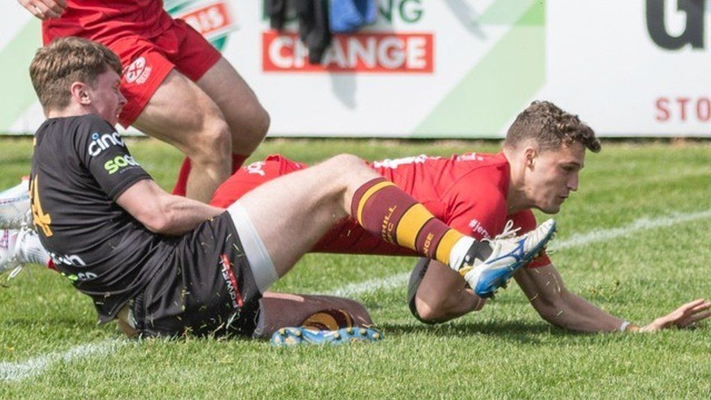 A Jersey Reds player scores a try