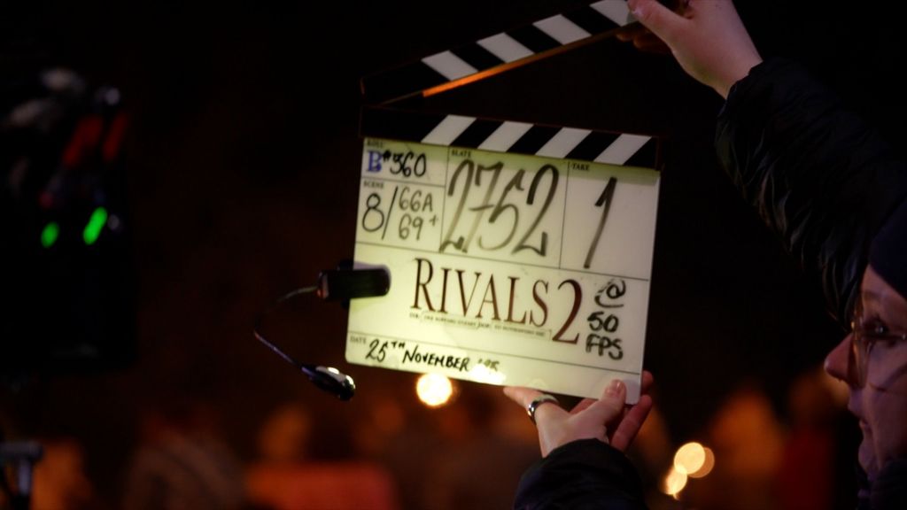 A closeup of the clapper, which has 'Rivals 2' written on it, and then lots of other numbers to do with the scene and date, which says 25 November.