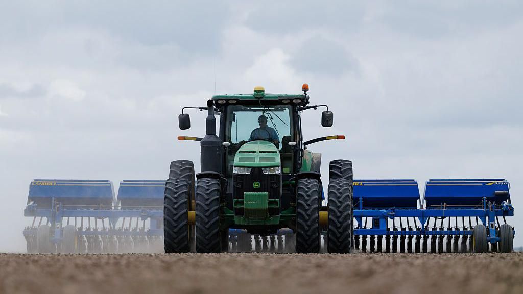 A farmer plants rice at a farm near El Campo, Texas, US, on Wednesday, March 4, 2026. The USDA forecasts US rice production at 208.5 million hundredweight for the 2025/26 crop year, as farmers plant more acres to offset lower yields per acre