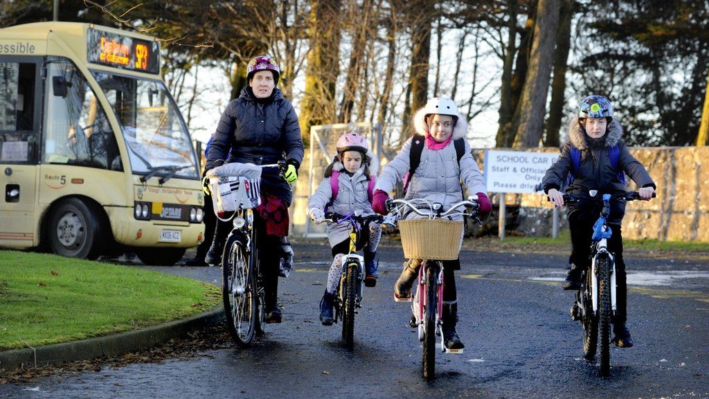 Family cycling to school