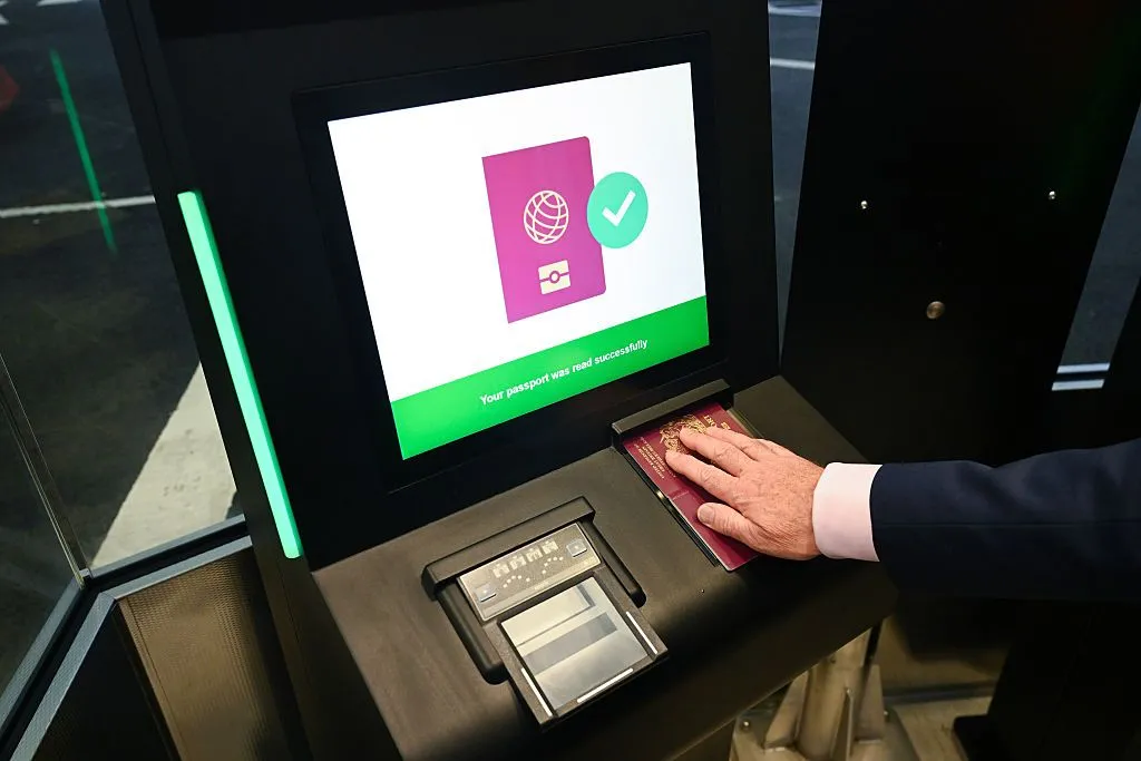 An employee scans a passport during a demonstration of the new Entry/Exit System, known as EES, at the Eurotunnel terminal in Folkestone, UK, on Tuesday, Sept. 23, 2025.