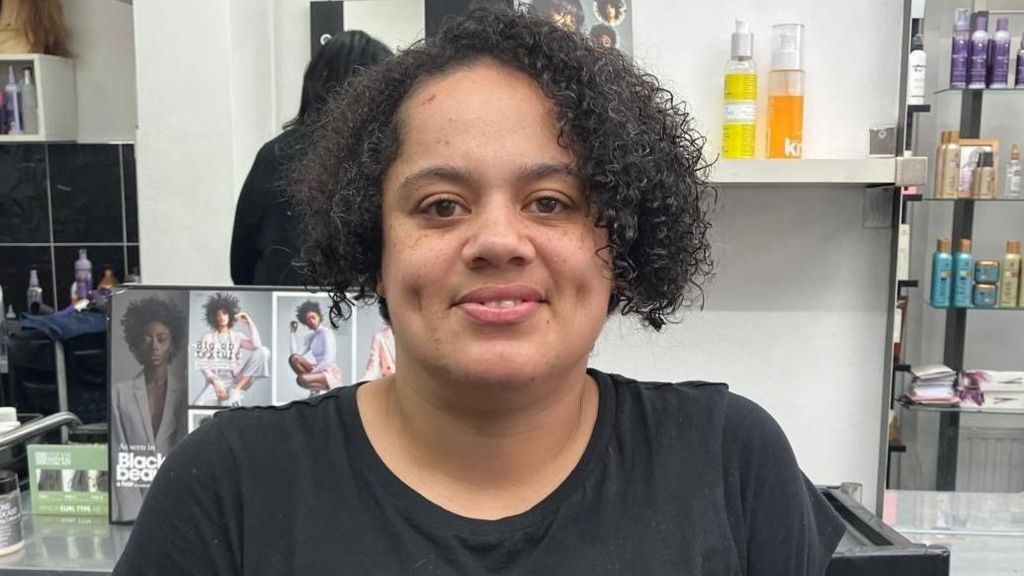 Kelly McDermott smiling in a hair salon