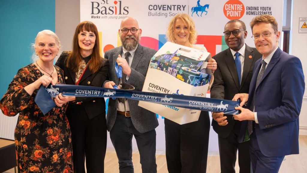 Six people cutting a Coventry Building Society ribbon