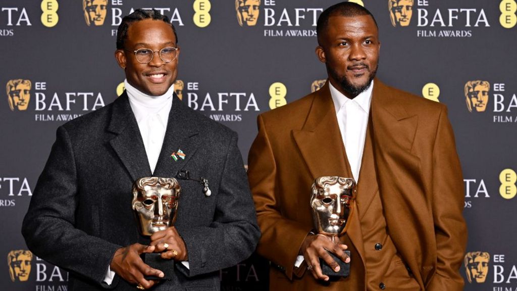 Akinola Davies Jr. and Wale Davies with the Outstanding Debut by a British Writer, Director or Producer for 'My Father's Shadow' during the EE BAFTA Film Awards 2026 at The Royal Festival Hall on February 22, 2026 in London, England