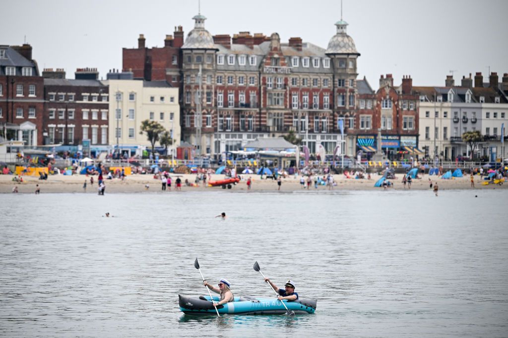 A couple paddle a kayak in Weymouth bay