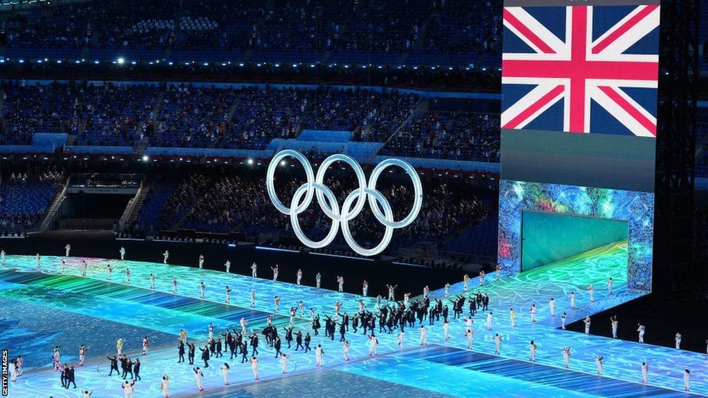 Flag bearers Eve Muirhead and Dave Ryding of Team Great Britain carry their flag during the Opening Ceremony of the Beijing 2022 Winter Olympics