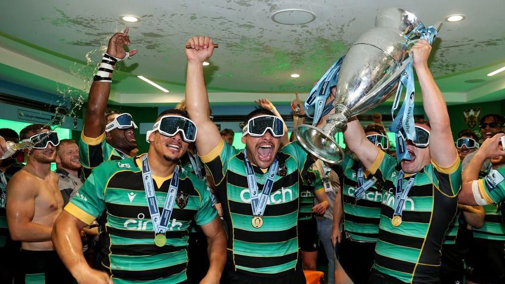 Northampton players celebrating in the changing room wearing ski goggles