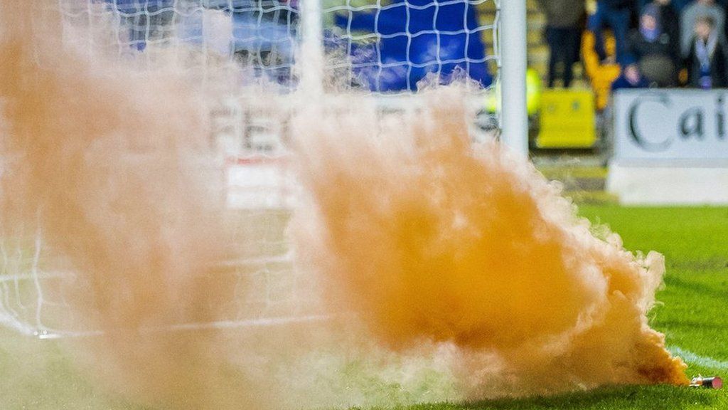A pyrotechnic on a football pitch