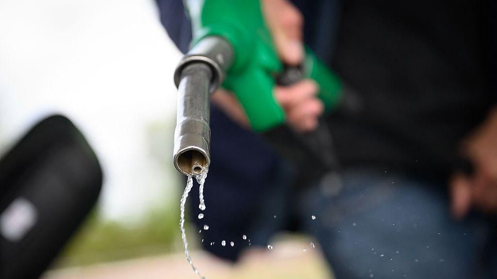 Petrol drips out of a fuel hose at a petrol station in Saint-Etienne-de-Montluc, western France, on 15 April, 2026.