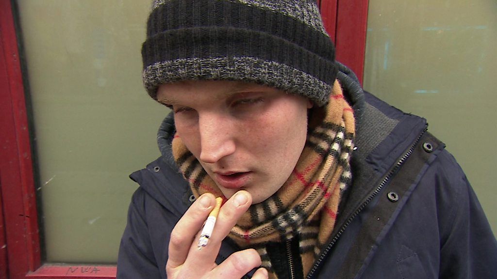 Elliot, a drug user, smoking a cigarette
