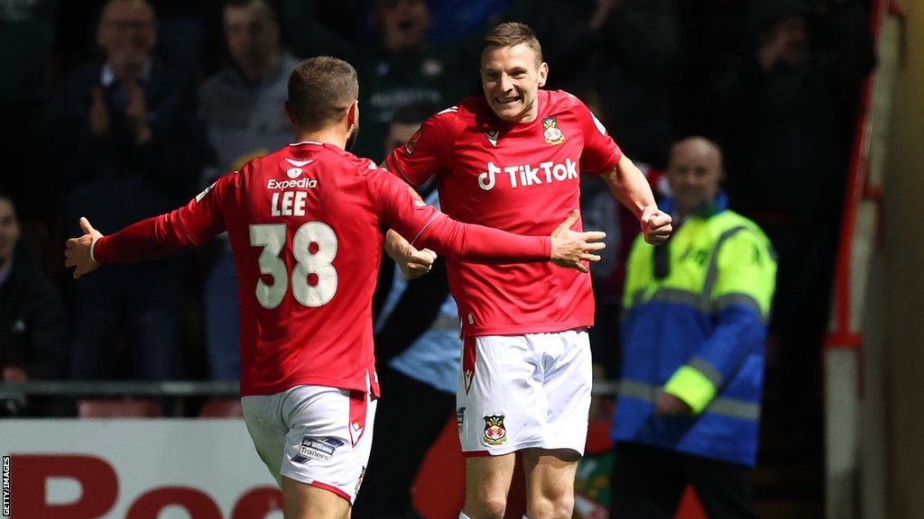 Paul Mullin celebrates with Elliot Lee after scoring his 45th goal of the season for Wrexham