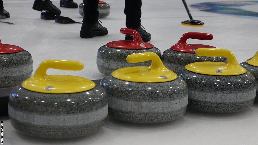 Curling stones resting on an ice rink