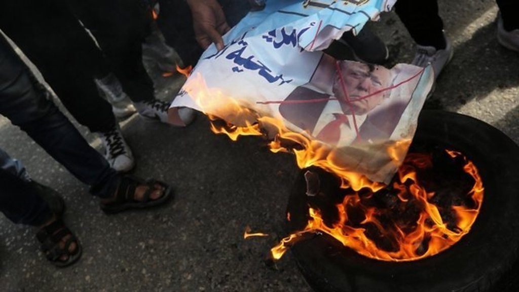 Palestinians burn Trump poster