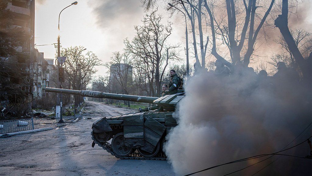 A pro-Russian tank lets out a cloud of diesel smoke as it moves towards the Azovstal works, Mariupol