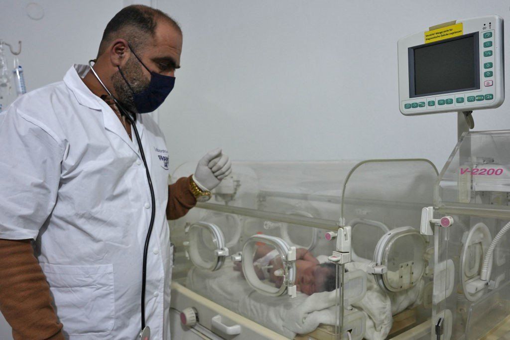 Doctor looking after orphaned baby in hospital