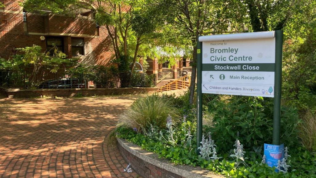 General view of the exterior of Bromley Civic Centre, a brick building with a brick path and green and white sign