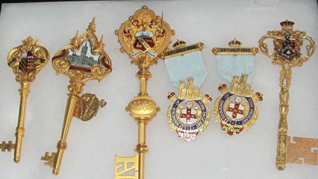 A collection of four ornate keys and two ceremonial fobs belonging to Princess Louise