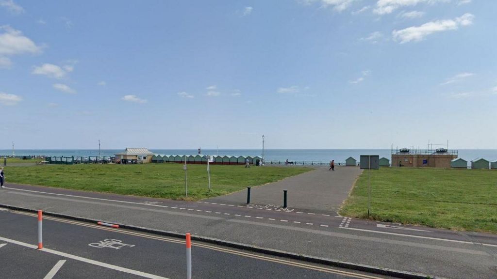 Hove Lawns with a cafe and beach huts seen before the sea