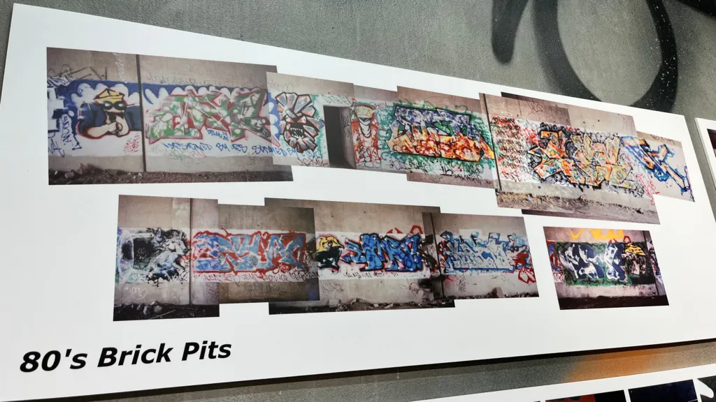 A white poster exhibit depicting street art in the city during the 1980s