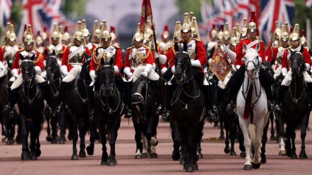 Members of the Household Cavalry ride on horseback as they take part in rehearsals for Trooping the Colour