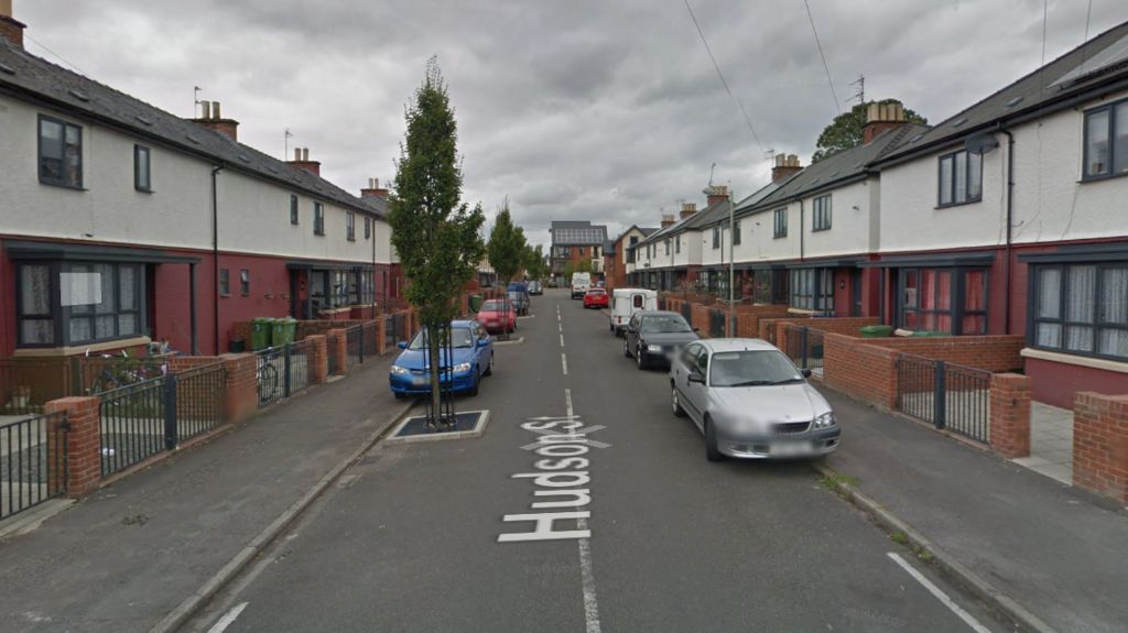 Google Maps image of Hudson Street in Cheltenham. Houses are lining both sides of the street and cars are parked. 