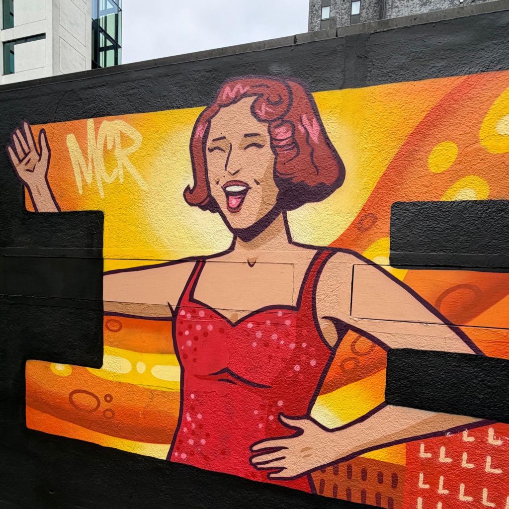 A mural shows pop star Raye in the centre of Manchester 