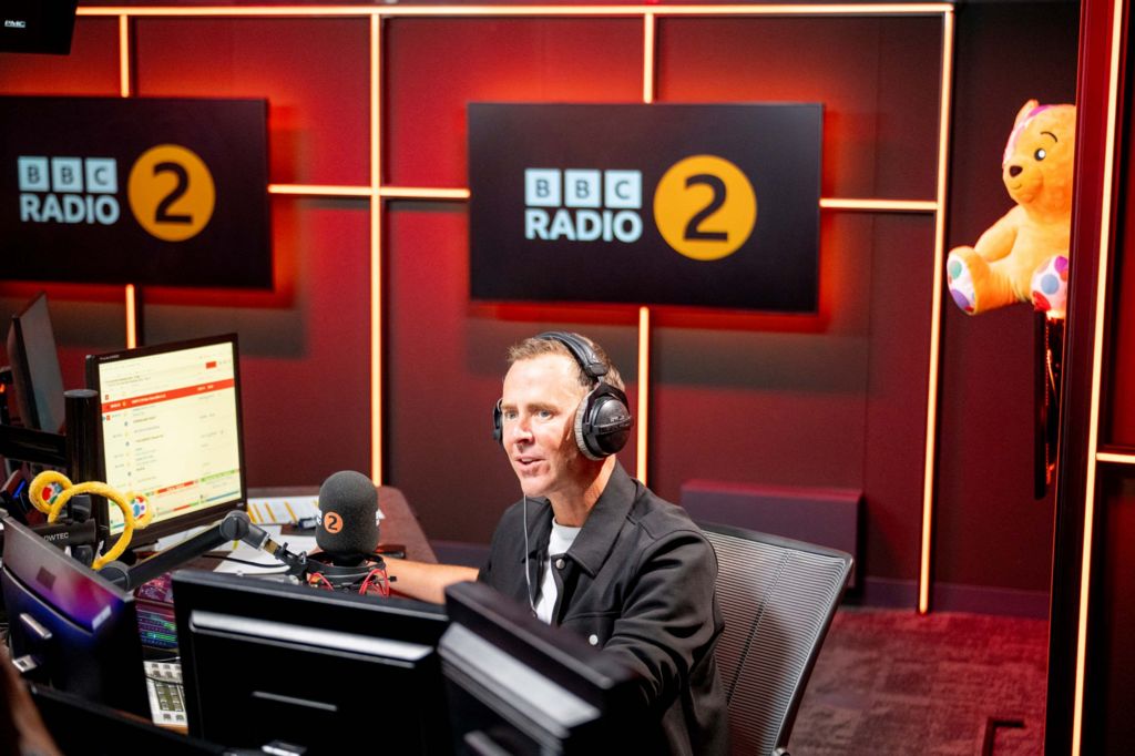 Scott Mills in the Radio 2 studio with headphones on