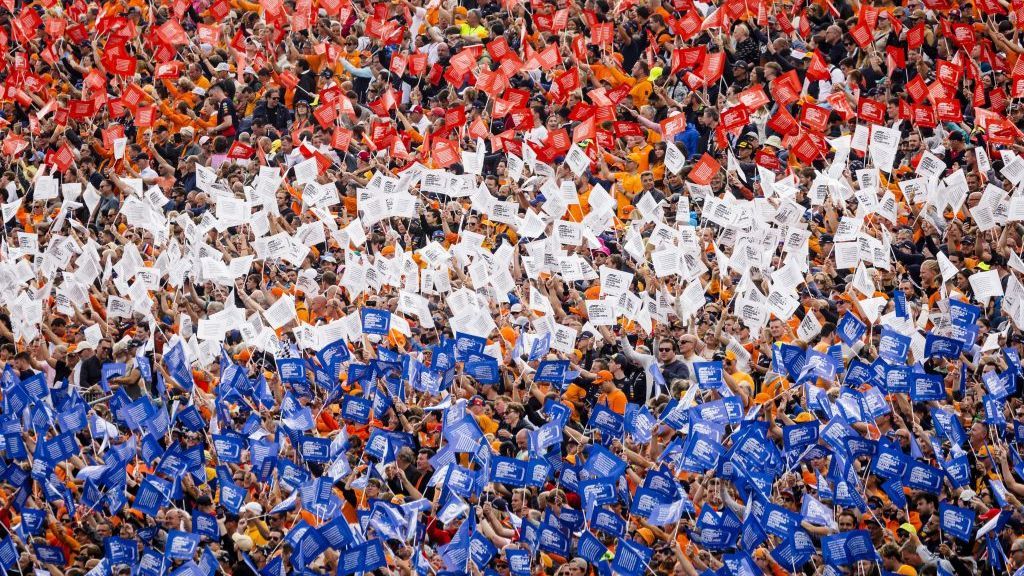 Dutch fans hold red, white and blue flags in the stands at Zandvoort 