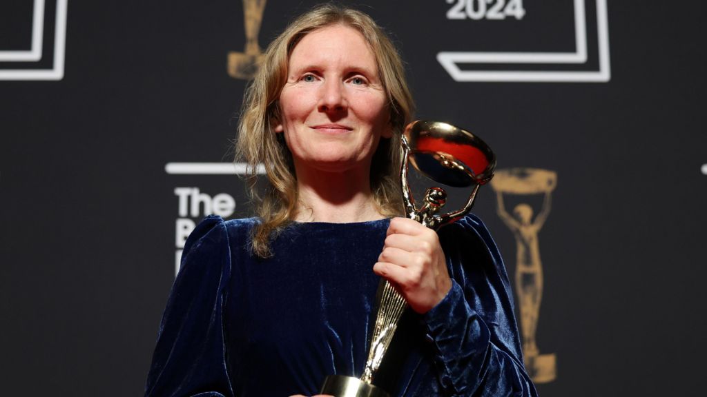 Samantha Harvey holding the Booker Prize trophy at the 2024 ceremony