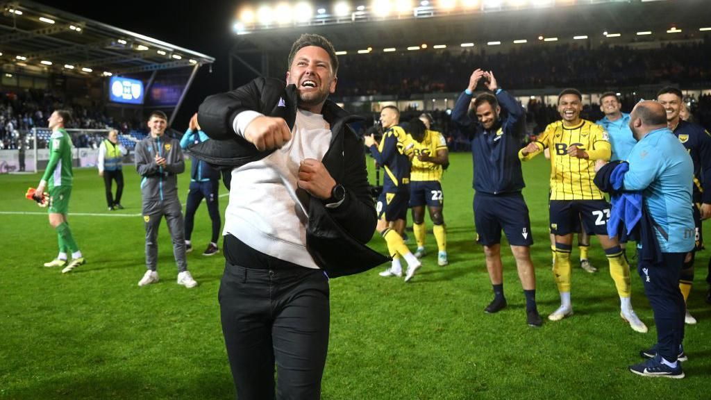 Des Buckingham, Manager of Oxford United, celebrates with the fans after reaching the League One Play-Off Final