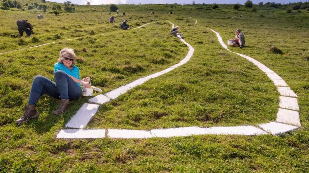 Volunteers repainting the Long Man on Thursday