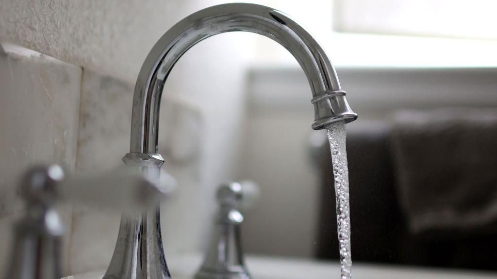 Water falls from a tap