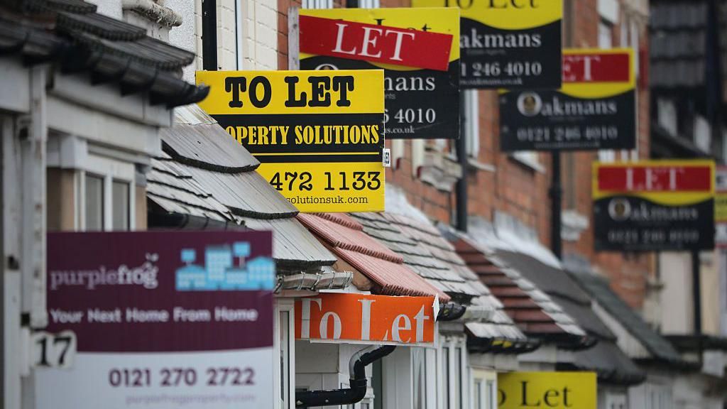 Host of lettings signs outside terraced homes