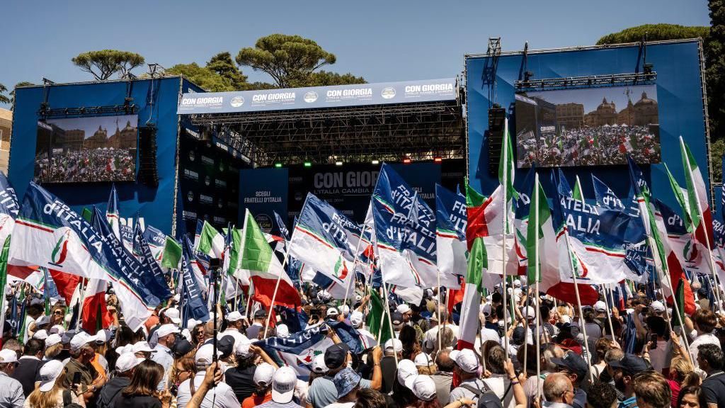 Supporters wave flags in support of Brothers of Italy ahead of elections