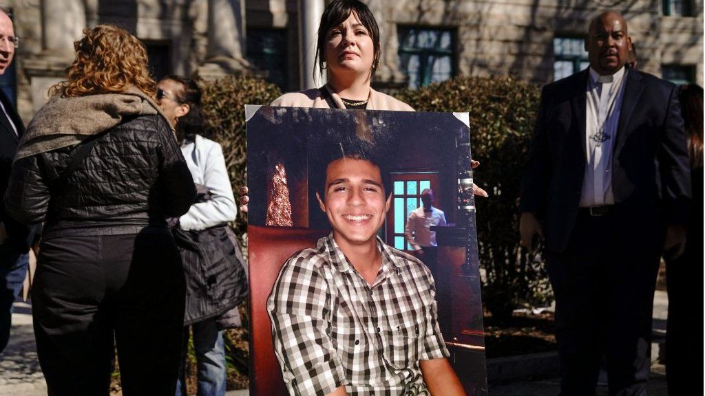 Sister-in-law, Fiona Paez, holds a photograph of environmental activist Manuel Teran