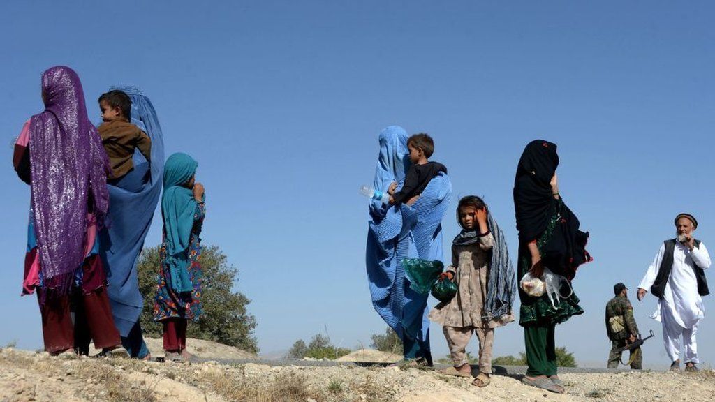 Afghan women with their children flee a US air strike in August 2017