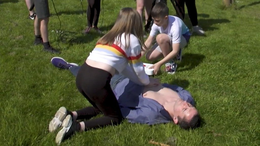 School pupils making a film about defibrillators.