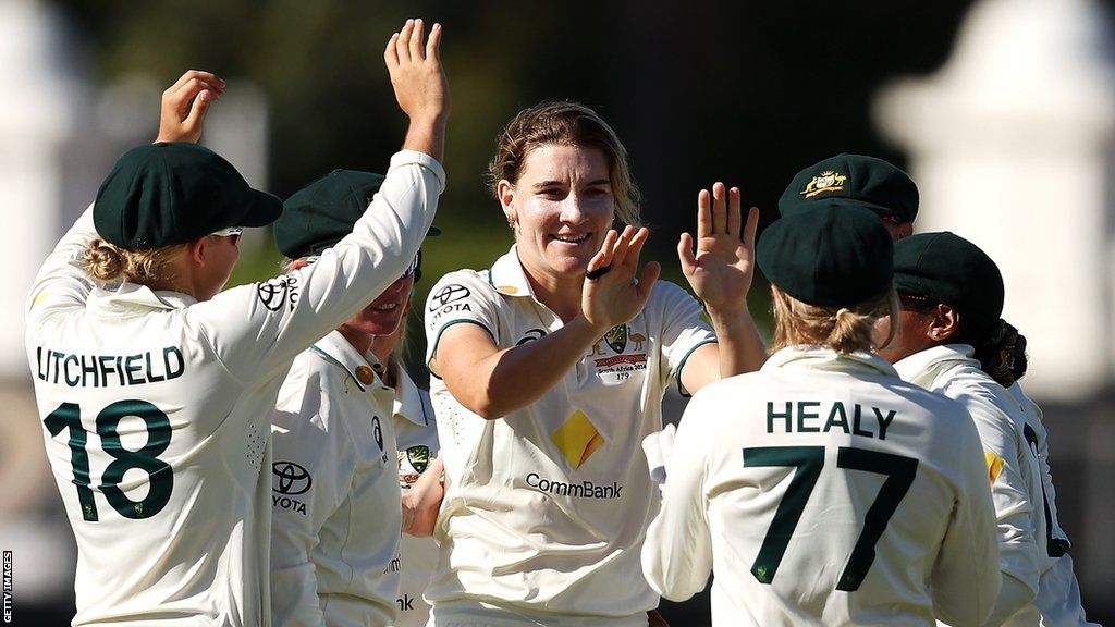 Annabel Sutherland (centre) celebrates taking a wicket with her Australia team-mates