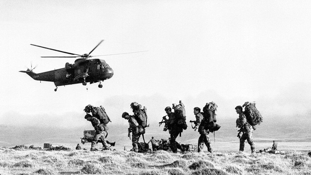 A Royal Navy Westland Sea King HC.4 of 825 Naval Air Squadron takes off after transporting J Company, 42 Commando, Royal Marines from Port San Carlos to Darwin, June 1982