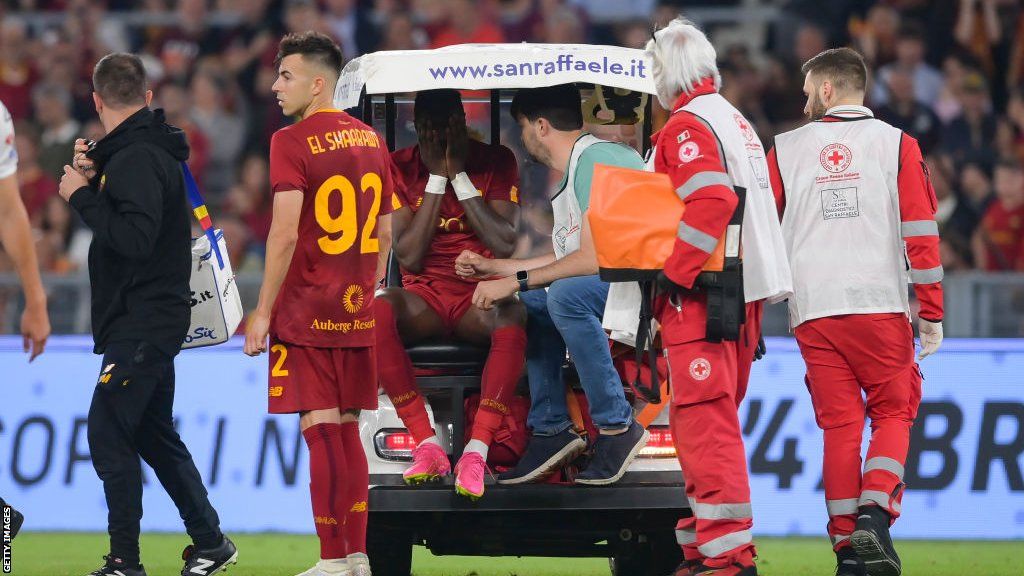 Roma striker Tammy Abraham leaves the field in a buggy