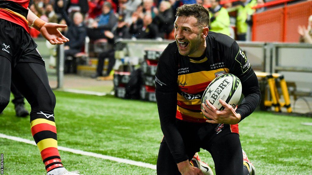 Jonny May smiles as he crosses the line to score a try