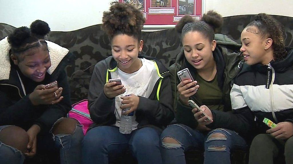 Girls playing with their phones