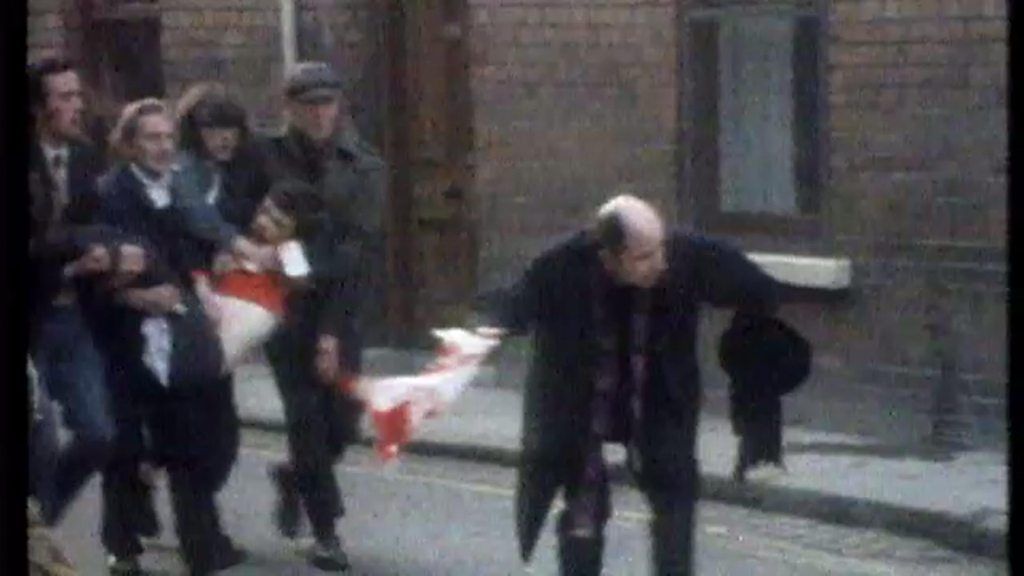 Edward Daly waves a blood-stained handkerchief as a group carries Jackie Duddy, Londonderry, 30 January 1972
