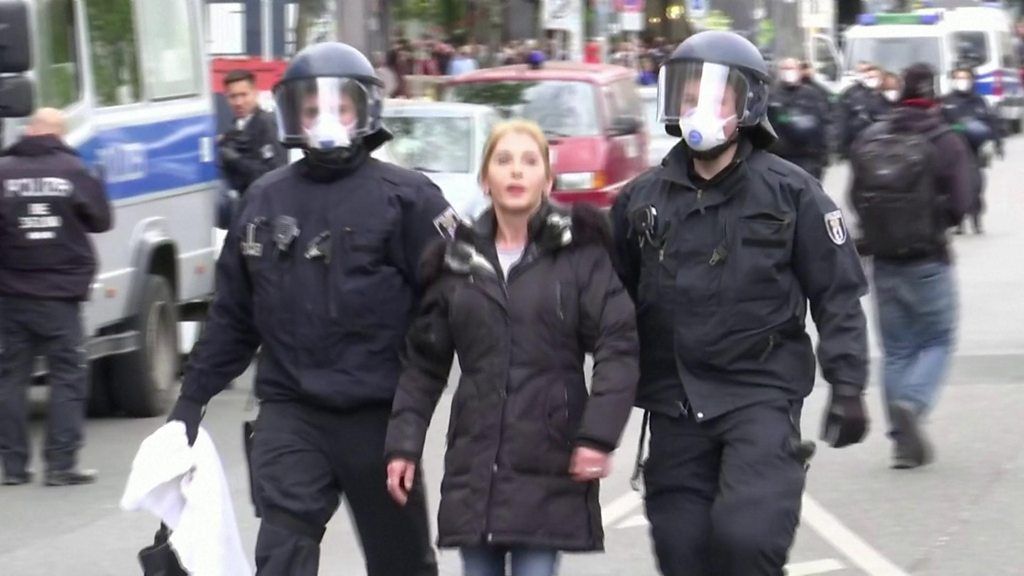 Police in Berlin lead woman away