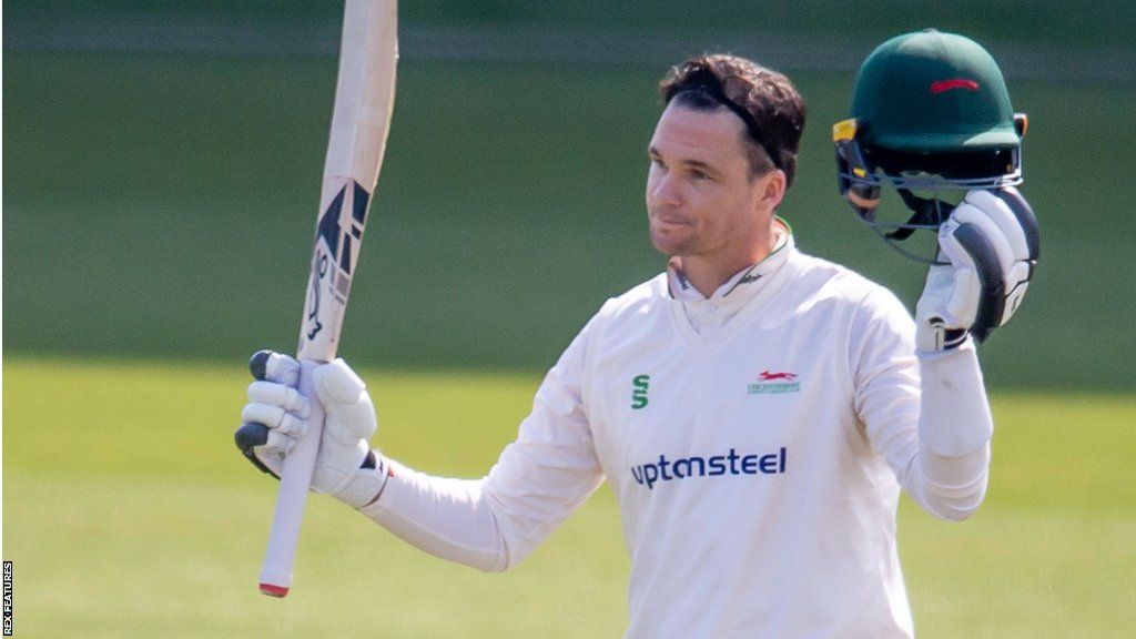 Peter Handscomb holds his bat and helmet up after scoring a century for Leicestershire