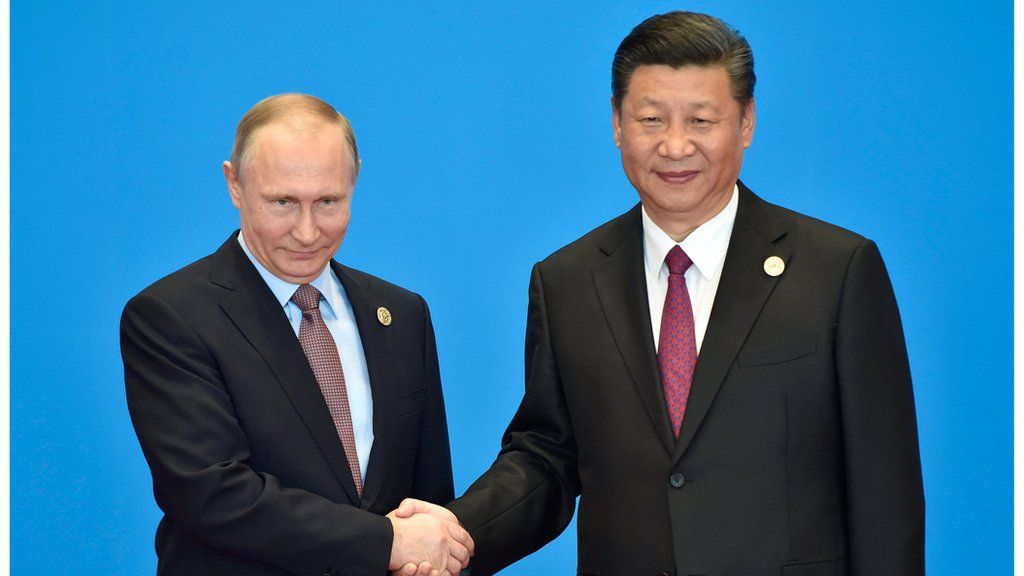 Putin and Xi shake hands