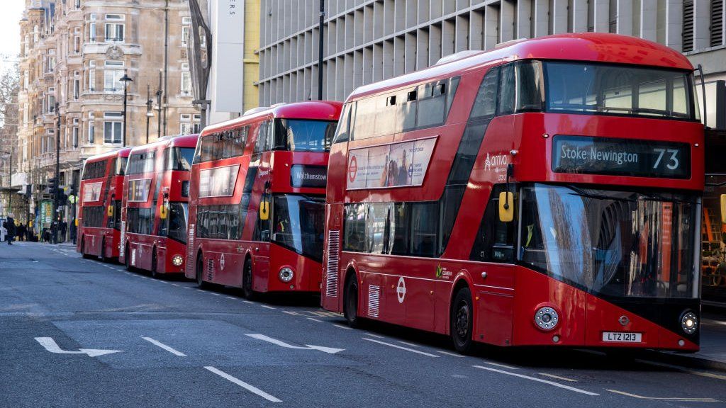 Red London New Routemaster buses parked in-line just off Oxford Street on 6th February 2023